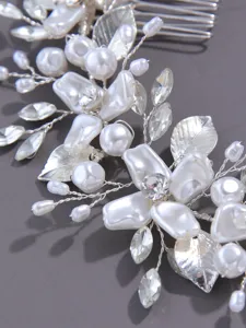 Silver bridal hair comb detail with pearls and rhinestones for wedding updo hairstyles.