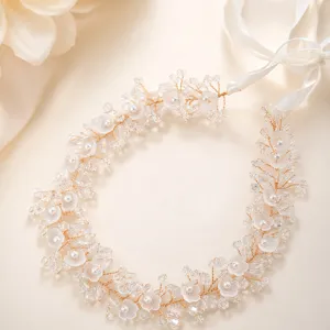 Stunning bridal hair vine with white floral pearls and clear crystals for wedding style.