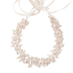 Elegant crystal and pearl bridal hair vine with white ribbon for wedding party wear.