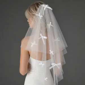 White double layer bridal veil with sweet bows for wedding photography and bridal wear styling.