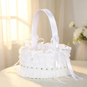 Detailed view of the white lace wedding flower basket featuring delicate pearl and bow decor.