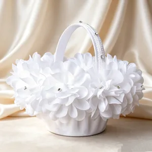 Elegant white wedding flower basket with layered fabric petals, lace and rhinestones for bride.