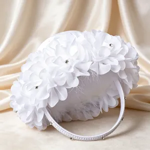 White wedding flower girl basket with rhinestones and floral decoration for ceremonies.