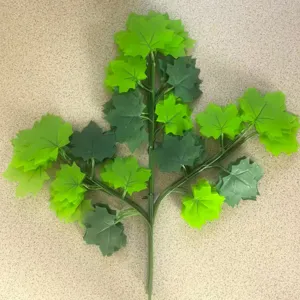 Artificial green maple leaf branch for home decor, plastic foliage plant stem detail.