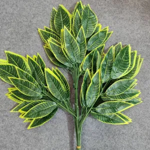 Detailed view of artificial mango leaves branch with green and yellow edge design for decor.