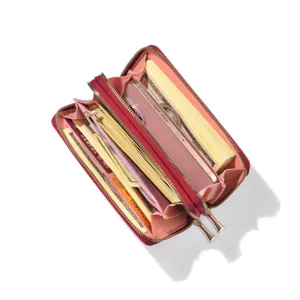 Interior detail of red women long zipper wallet with multiple card slots and cash compartments.