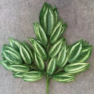Detailed close-up of artificial green plant leaves with realistic white vein texture pattern.