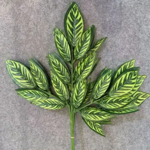 Artificial green leaf branch detail, realistic plant foliage for home decor and floral design.