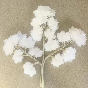 White artificial maple leaf branch for home decor, plastic foliage plant for landscaping detail.