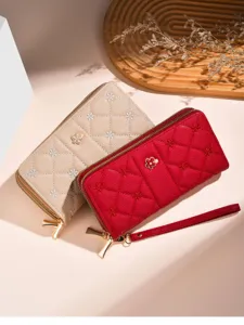 Women quilted long wallet with embroidered floral design, zipper closure and wrist strap.