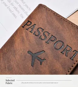 Vintage brown leather passport holder with embossed travel design and clear texture details.