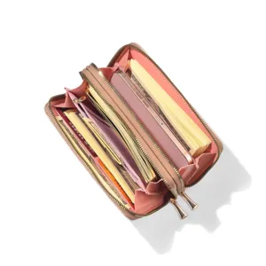 Detailed view of women pink long wallet with double zippers, card slots and cash pockets.