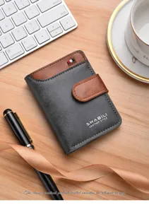 Detail view of a vintage two-tone leather wallet with snap closure and card slots.
