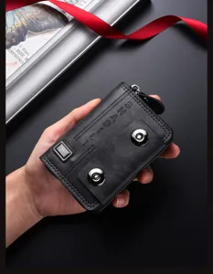 Detailed view of black leather card holder with double snap buttons and accordion design.
