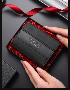 Detailed shot of men's black leather textured card holder wallet with multiple slots in gift box.