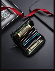 Close-up detail of black leather accordion card holder with multiple slots and zipper.