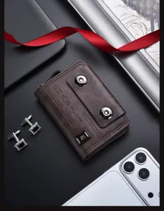 Detailed view of brown leather card holder wallet with double snap buttons and sleek design.
