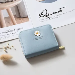 Light blue short wallet for women with cute daisy flower emblem and secure zipper coin purse design.