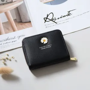 Detail view of black short zipper wallet featuring a cute white daisy accent and compact design.
