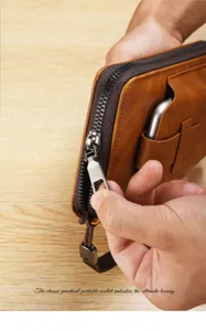Detail view of brown men long wallet with zipper closure and convenient phone slot pocket.