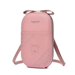 Cute pink crossbody phone bag with bow accent, embroidered bear and stylish details.