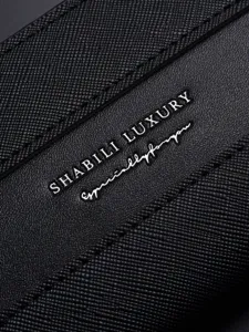 Men's black saffiano leather card holder wallet with silver luxury text print close up view