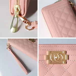 Close-up details of women's pink quilted long wallet, zipper pull, and metal clasp.