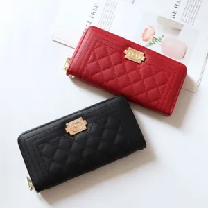 Women's long quilted zip wallet with metal lock clasp, stylish PU leather clutch bag for use.