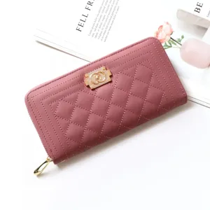 Detail of pink quilted long zipper wallet for women with stylish metal clasp and large capacity.