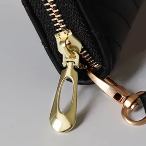 Black leather long wallet main product showcase featuring elegant golden zipper and quilted design.