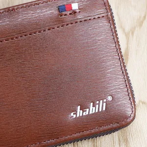 Brown short zipper wallet for men with card slots, textured leather and stylish ribbon.