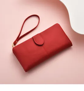 Red long wallet detail view, PU leather clutch purse with wrist strap and snap closure.