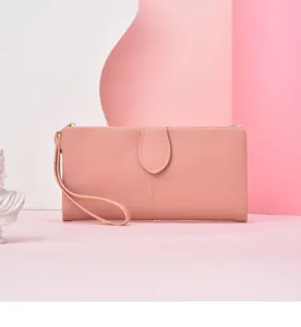Pink long wallet detail showing the elegant wrist strap and secure button closure.