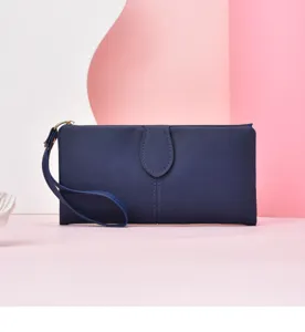 Women's long solid color wallet clutch with wrist strap and zipper, detailed product view.