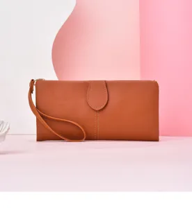 Close-up detail of the brown leather long wallet featuring a convenient wrist strap.
