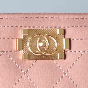 Pink quilted women's long wallet with gold lock clasp, stylish zipper clutch purse design.