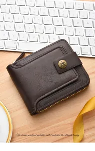 Close-up detail of vintage brown leather men wallet with zipper and snap closure on desk.