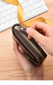 Close-up of a premium brown leather men's short wallet with zipper and buckle detail.