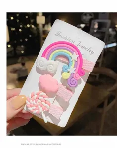 Detailansicht eines niedlichen Kinder Haarklammer Set mit Regenbogen, Wolke und Lutscher.