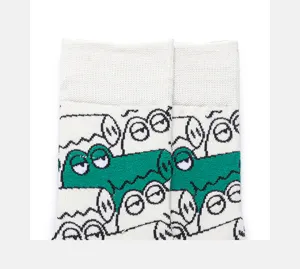 Close-up detail of cartoon crocodile pattern mid-tube cotton socks, soft knit texture, street style.