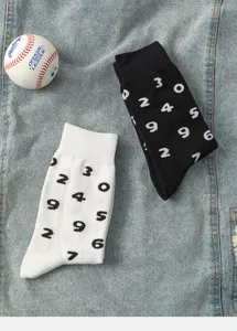 Detailed view of trendy mid-tube cotton socks featuring unique digital prints in black and white.