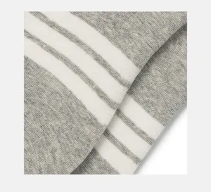 Grey and white striped sock fabric detail, soft cotton knit texture close-up view.