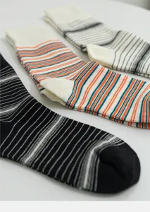 Detailed close-up shot of striped crew socks showing fine texture and neat stitching patterns.