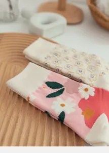 Detailed close-up of women's cotton mid-tube socks featuring cute floral patterns.