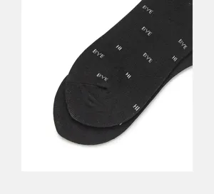 Black cotton crew socks detail shot featuring trendy white letter prints HI and BYE design.