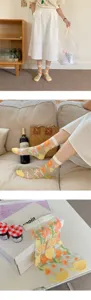 Sheer mesh crystal mid-tube socks with delicate floral embroidery and bright yellow trim.
