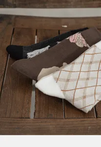 Close-up detail of vintage style women socks set featuring floral and argyle patterns.