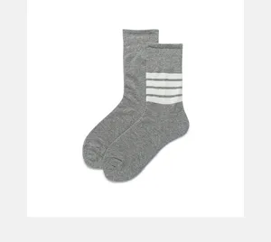 Grey women's mid-calf cotton socks featuring classic white four-stripe design for casual wear.
