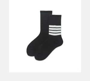 Classic black mid-calf socks featuring four white stripes, comfortable cotton sports style.