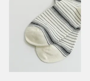 Black and white striped cotton socks detail view, comfortable breathable spring autumn casual wear.